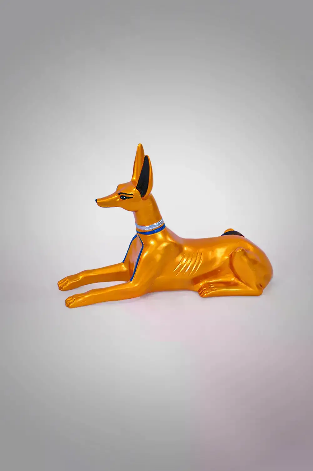 Beautifully detailed Anubis lying down statue golden color